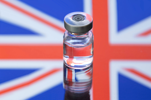 Vial ampoule vaccine for Corona Virus Covid-19 with national Flag of UK