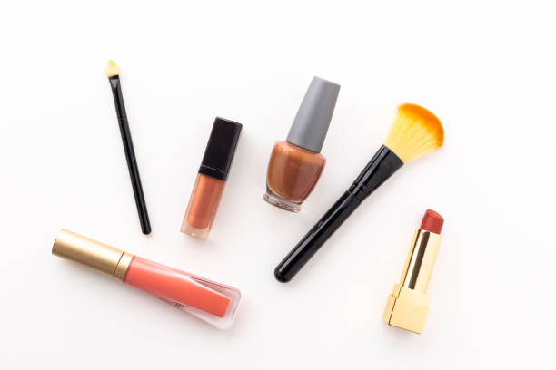 istock Plenty of makeup on the white table with eyelash brush, eye shadow, lipstick. 1296134727