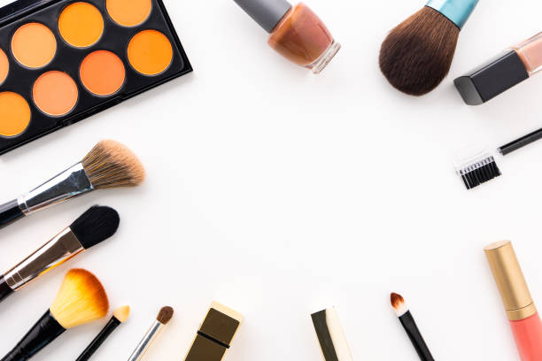 istock Plenty of makeup on the white table with eyelash brush, eye shadow, lipstick with copy space for text. 1296134752