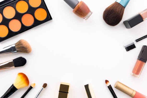 istock Plenty of makeup on the white table with eyelash brush, eye shadow, lipstick with copy space for text. 1296135465