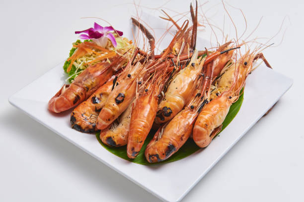 istock Grilled shrimp served on a white plate Popular seafood dishes 1296135735
