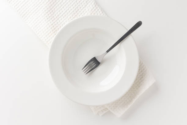 istock White empty plates set on the table with forks and tablecloths. Ready to eat 1296135932