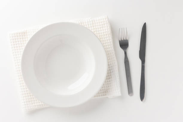 istock White empty plates set on the table with knives and forks and tablecloths. Ready to eat 1296136142