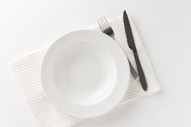 istock White empty plates set on the table with knives and forks and tablecloths. Ready to eat 1296136147