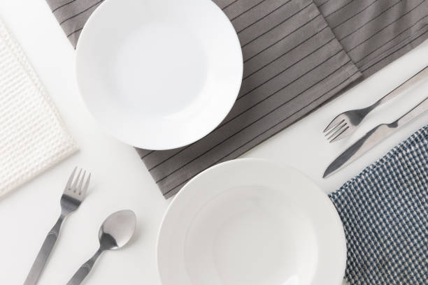 istock White empty plates set on the table with knives and forks and tablecloths. Ready to eat 1296136176