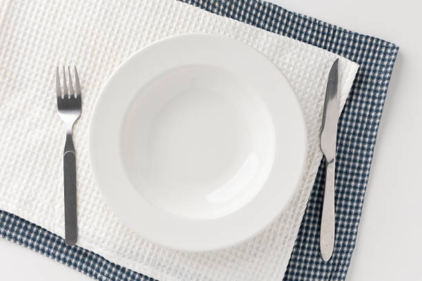 istock White empty plates set on the table with knives and forks and tablecloths. Ready to eat 1296136182