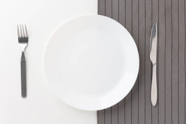 istock White empty plates set on the table with knives and forks and tablecloths. Ready to eat 1296136185