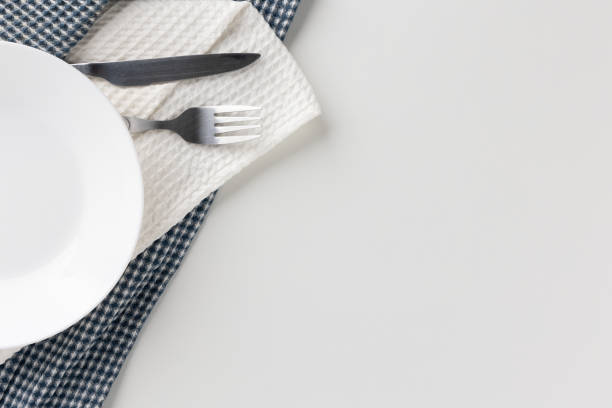 istock White empty plates set on the table with knives and forks and tablecloths. Ready to eat 1296136234