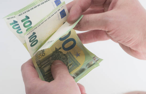istock holding one hundred euro bills in hand 1296136412
