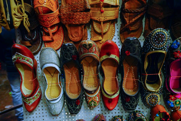 indian shoes with electric light at evening  from leather on main bazar road in dheli - textile textile industry warehouse store imagens e fotografias de stock