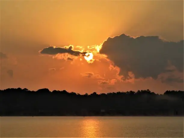 It's almost like one of these clouds is attempting to steal the sun in this beautiful Lake Sinclair morning sunrise shot.