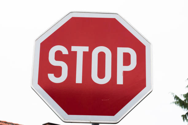 istock red stop sign in traffic 1296139107