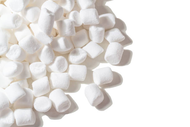 Isolate of white marshmallows on a white background with hard shadows. Copy space