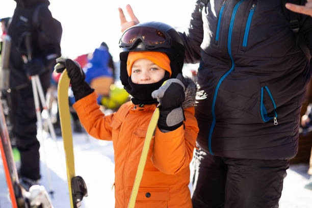 istock The father helps his son to fasten his helmet. 1296141095