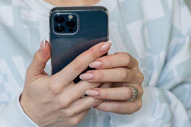istock Woman holds mobile phone in hand and texting 1296141114