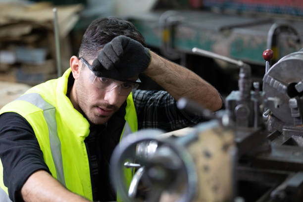 istock engineer man or factory worker feeling tired for working on the machine in factory 1296141264