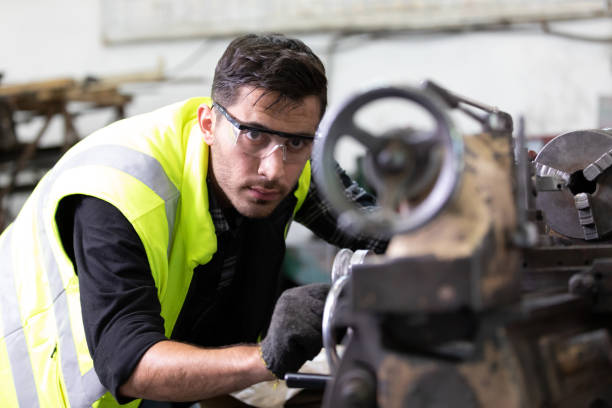 istock engineer man or factory worker milling or working on the machine in factory 1296141360