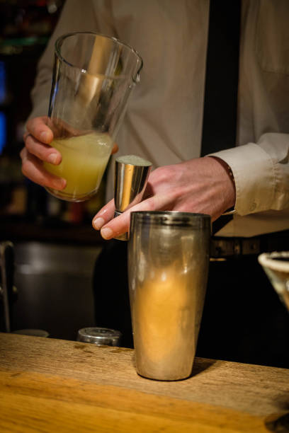 istock Bartender hands cocktail shaker and retro style glasses 1296144666