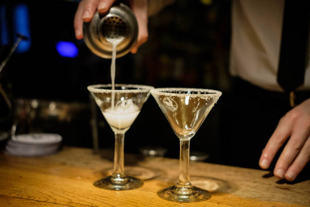 istock Bartender hands cocktail shaker and retro style glasses 1296144672