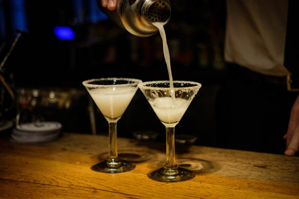 istock Bartender hands cocktail shaker and retro style glasses 1296144679