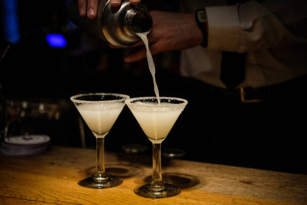 istock Bartender hands cocktail shaker and retro style glasses 1296144681