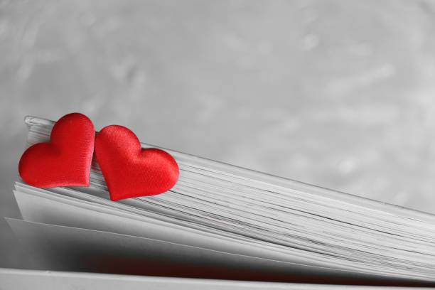 Two red hearts on pages of  book, monochrome retro effect , love in valentine's day concept Two red hearts on pages of  book, monochrome retro effect , love in valentine's day concept book heart shape valentines day copy space stock pictures, royalty-free photos & images