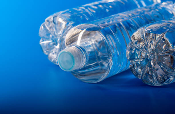 istock Mineral water bottle in studio on blue background 1296146153