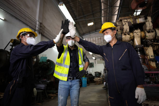 istock group of industrial technician worker giving high five or raise hands for success the project together in factory, new normal concept 1296147392