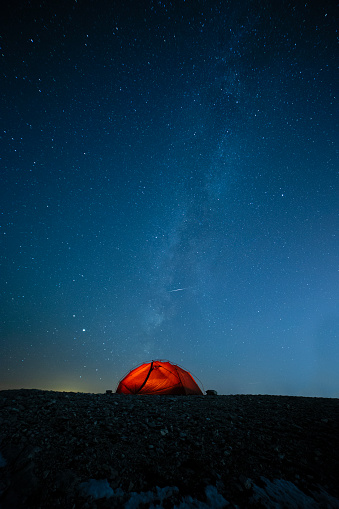 orange camping tent night stars