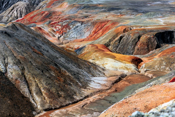 istock Apocalyptic landscape like a planet Mars surface. Solidified red-brown black Earth surface. Barren, cracked and scorched land. Global warming concept. Refractory clay quarries. 1296149051