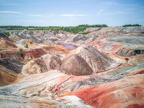 amazing  apocalyptic landscape like a planet mars surface. solidified red-brown black earth surface. barren, cracked and scorched land. global warming concept. refractory clay quarries. - solidified imagens e fotografias de stock