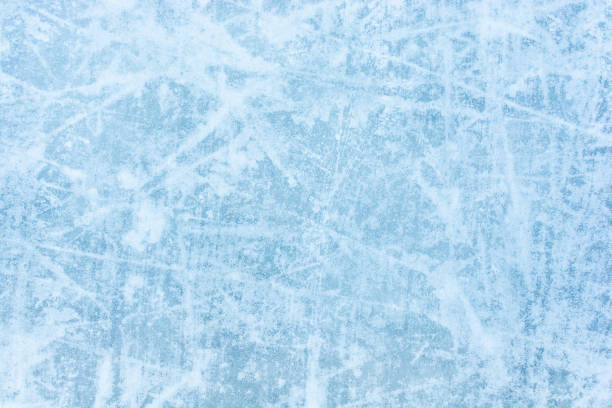 istock Ice blue background with skate tracks. Skating rink. 1296149125