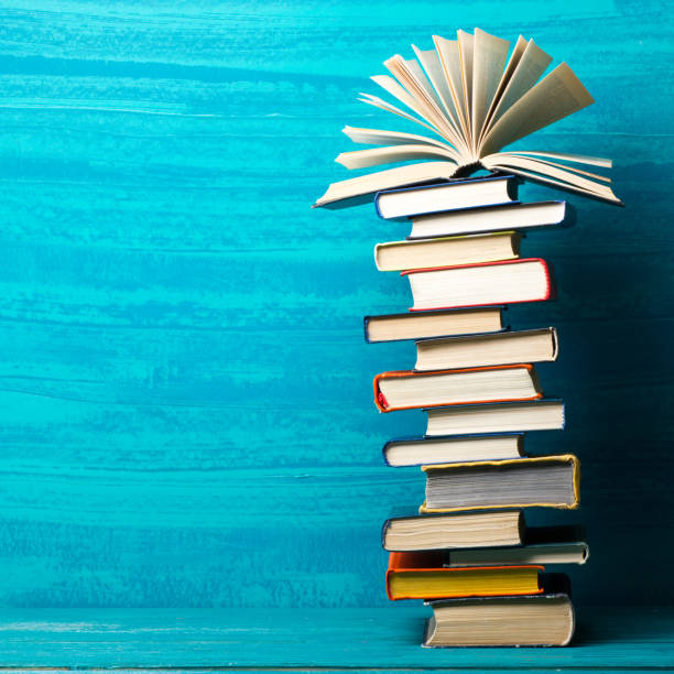 istock Books on wooden desk table and abstract background. Education background. Copy Space. Back to school. 1296149308