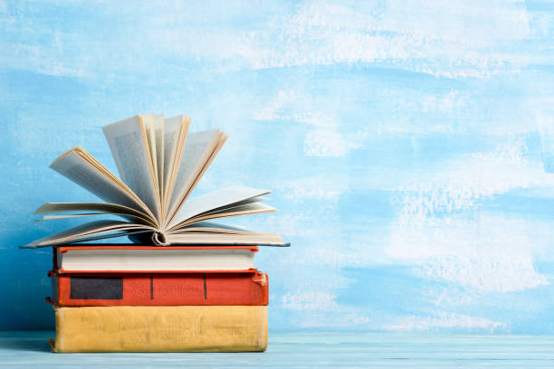 istock Books on wooden desk table and abstract background. Education background. Copy Space. Back to school. 1296149442