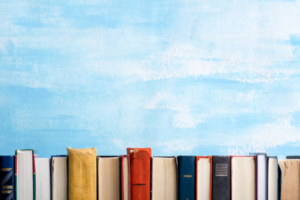 istock Books on wooden desk table and abstract background. Education background. Copy Space. Back to school. 1296149458