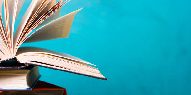 istock Books on wooden desk table and abstract background. Education background. Copy Space. Back to school. 1296149618