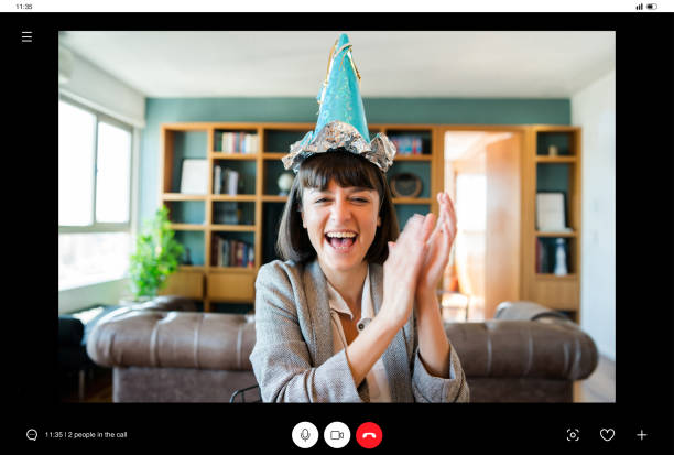Woman celebrating her birthday online at home. Portrait of young woman celebrating birthday on a video call from home. Woman celebrating birthday online in quarantine time. New normal lifestyle concept. virtual birthday celebration stock pictures, royalty-free photos & images