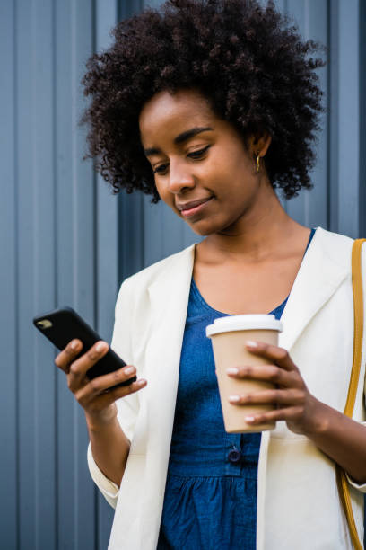 istock Business woman using her mobile phone outdoors. 1296149812