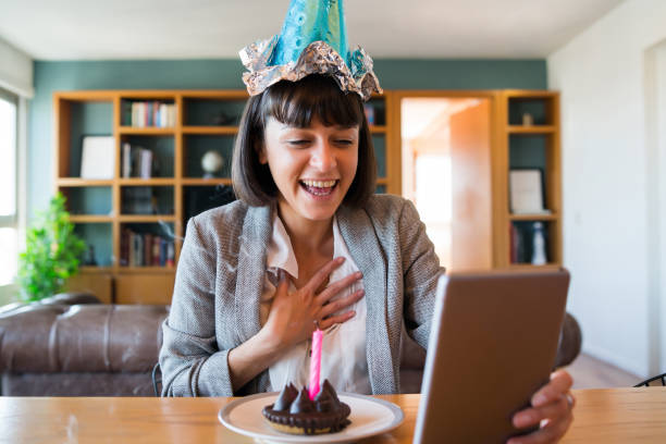 istock Woman celebrating her birthday on a video call. 1296149818