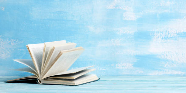 istock Books on wooden desk table and abstract background. Education background. Copy Space. Back to school. 1296151300
