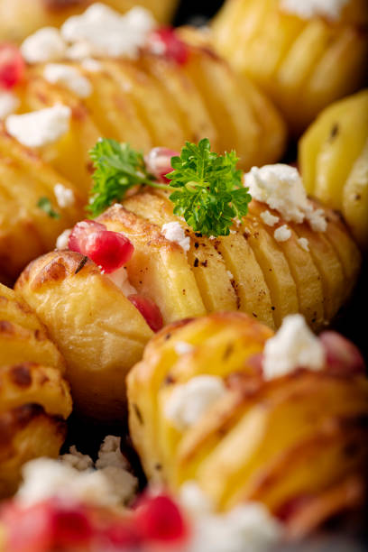 istock Hasselback Potatoes with Feta Cheese and Pomegranate Seeds. 1296151667