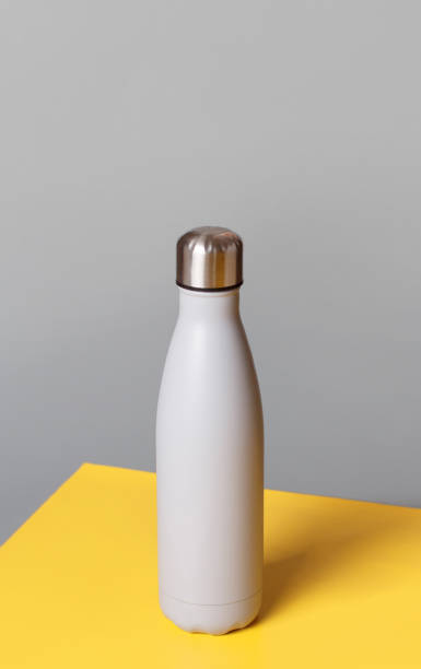 istock Grey reusable steel bottle on grey and yellow background 1296152583