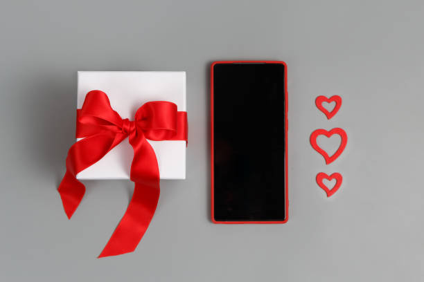 istock Valentines Day concept - Red Mobile phone, gift box with a bow and hearts 1296152967