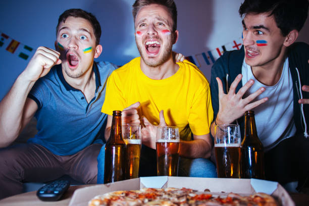 istock Sport fans watching a game together 1296153339