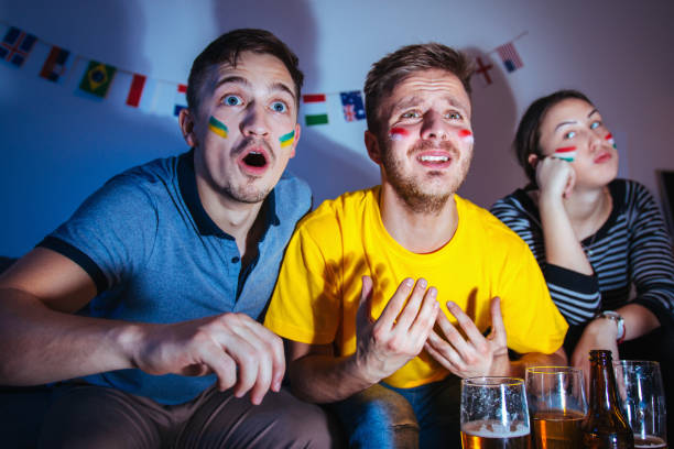 istock Sport fans watching a game together 1296153352