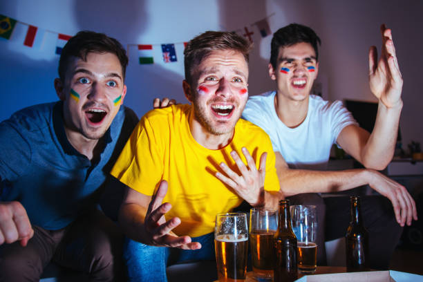 istock Sport fans watching a game together 1296153370