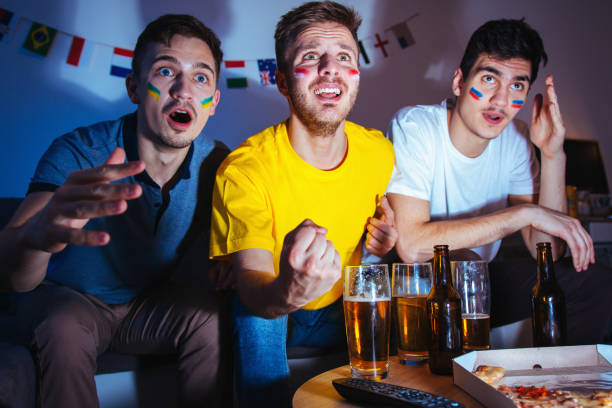 istock Sport fans watching a game together 1296153393