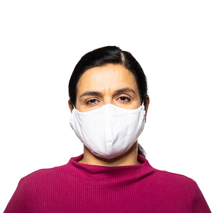 Portrait of mature woman with a face mask. Mature woman wearing a protective face mask on white background.