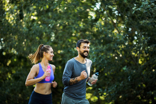 istock Young man and his girlfriend jogging, enjoying sunny day. 1296157214
