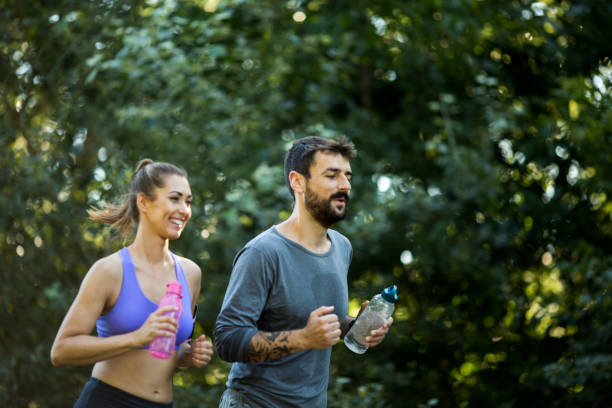 istock Beautiful couple jogging, having great time outside. 1296157237